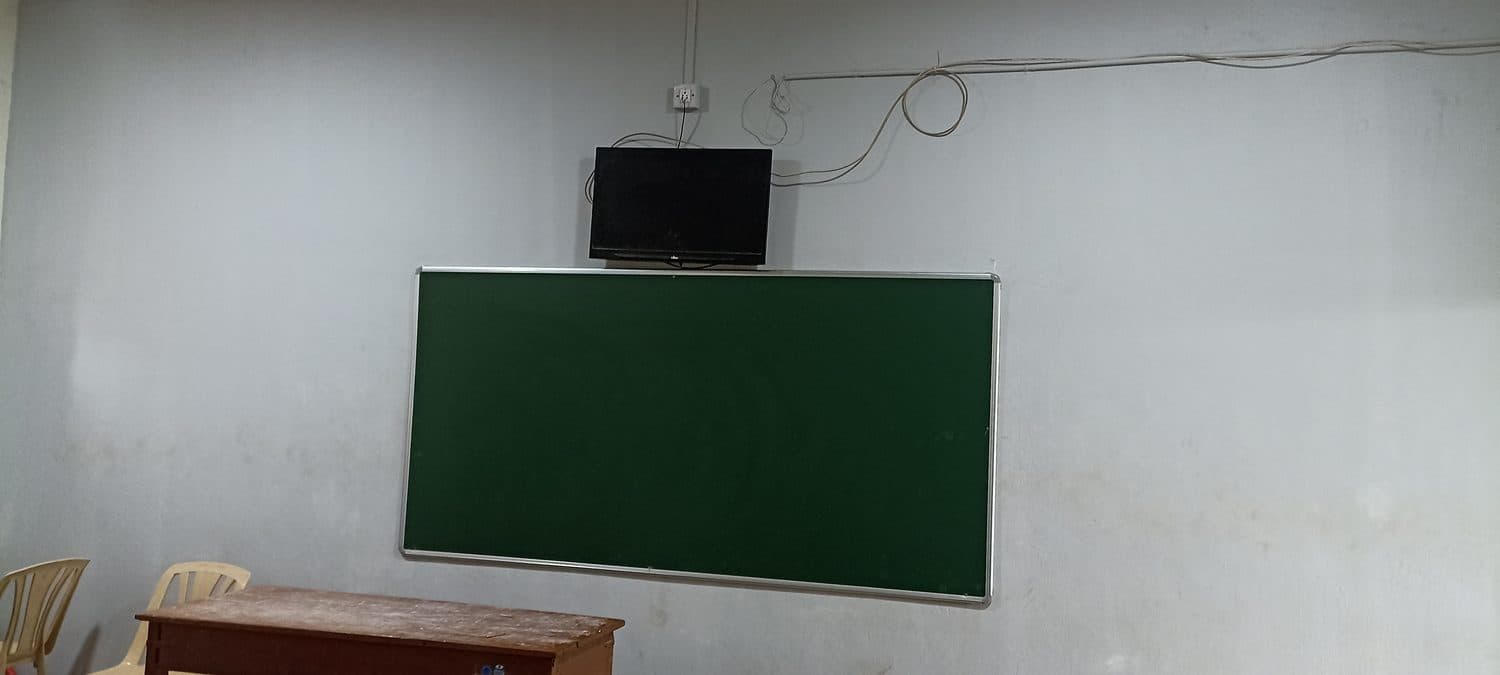 Green chalk board beside a wall-mounted display